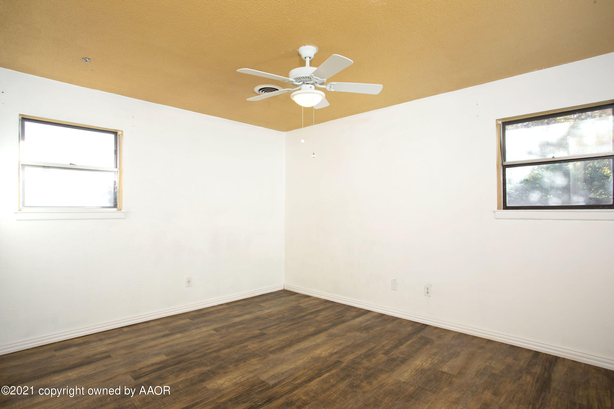 4313 Summit Circle Amarillo, TX 79109 - Photo 16 of 24 an empty room with wooden floor fan and windows
