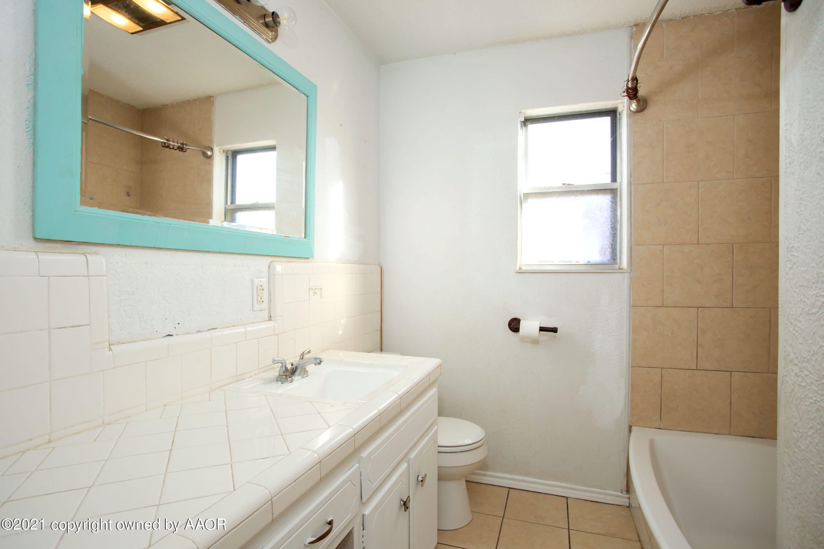 4313 Summit Circle Amarillo, TX 79109 - Photo 19 of 24 a bathroom with a sink a toilet and a mirror