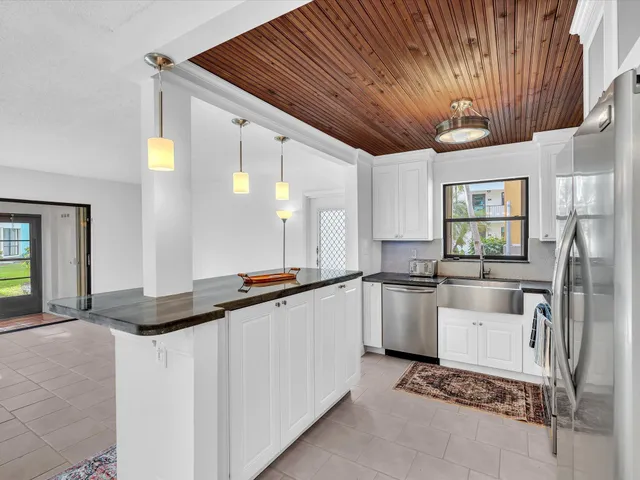 a large white kitchen with a large window
