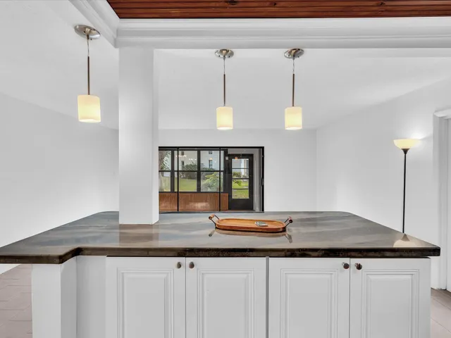 a kitchen with a sink and a wooden floor