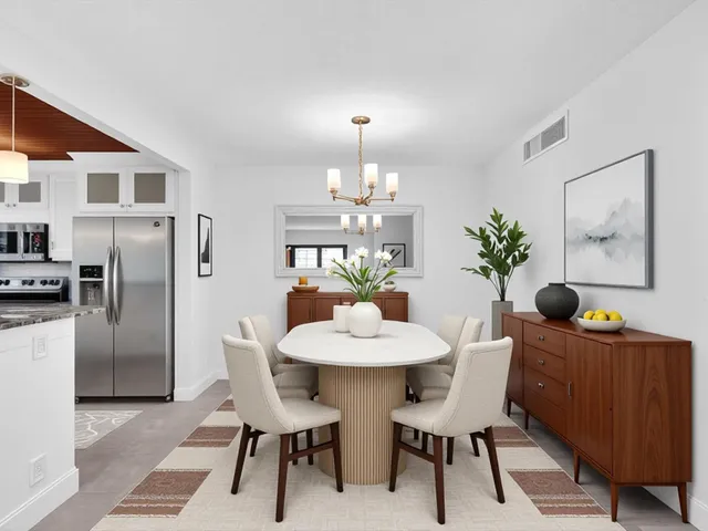 a dining room with furniture and window