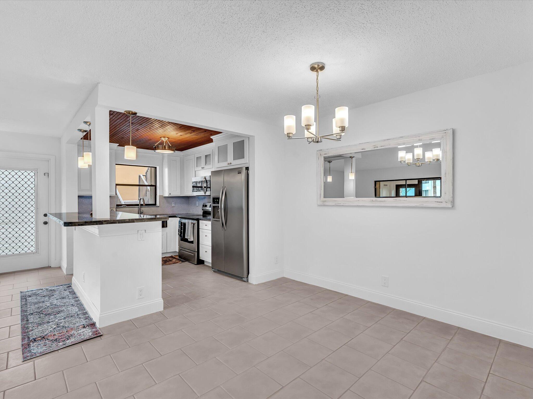 524 Osprey Drive, Unit 11B Delray Beach, FL 33444 - Photo 19 of 54 a view of a kitchen and an empty room