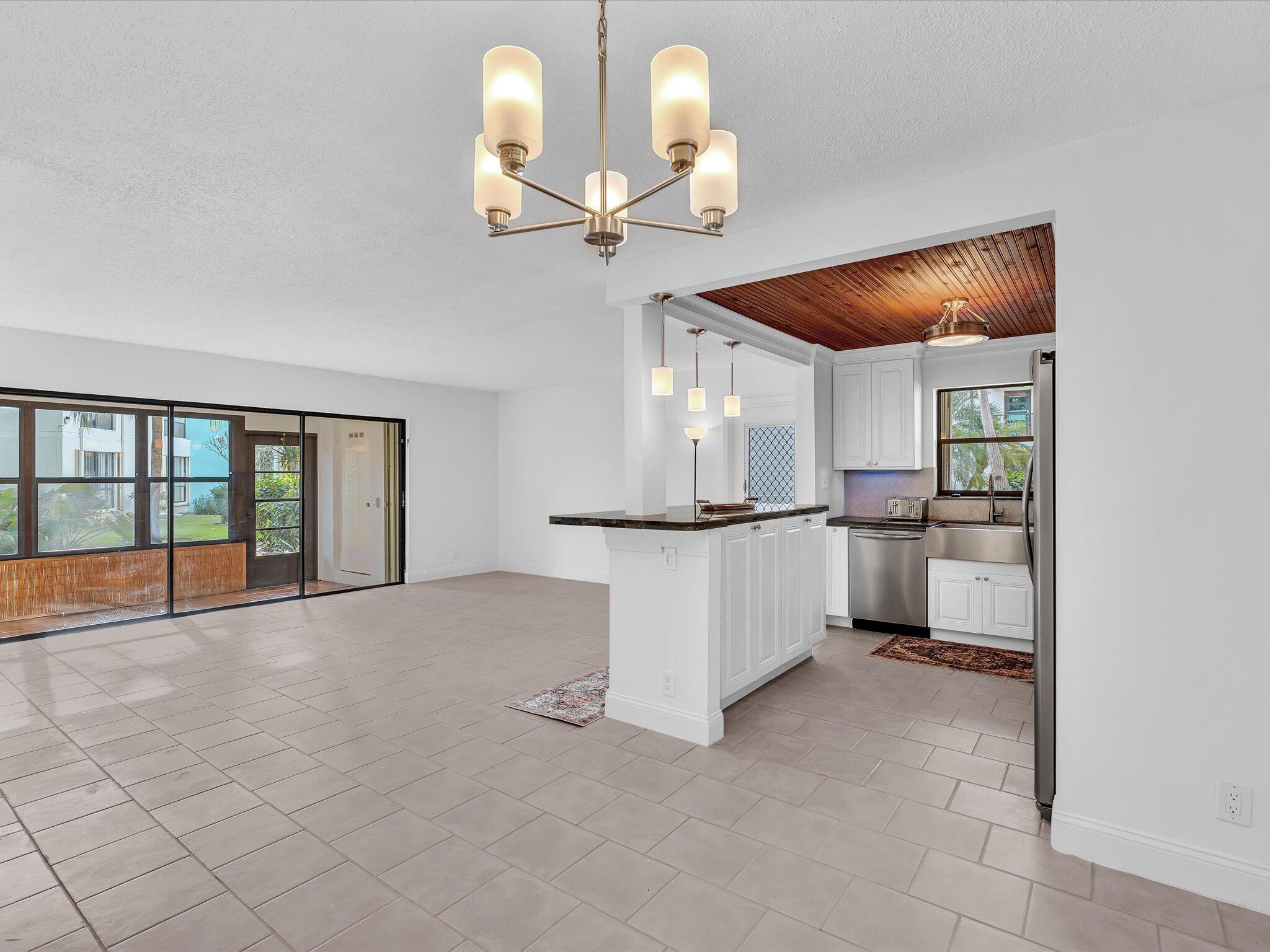 524 Osprey Drive, Unit 11B Delray Beach, FL 33444 - Photo 53 of 54 a view of a kitchen with furniture and a ceiling fan