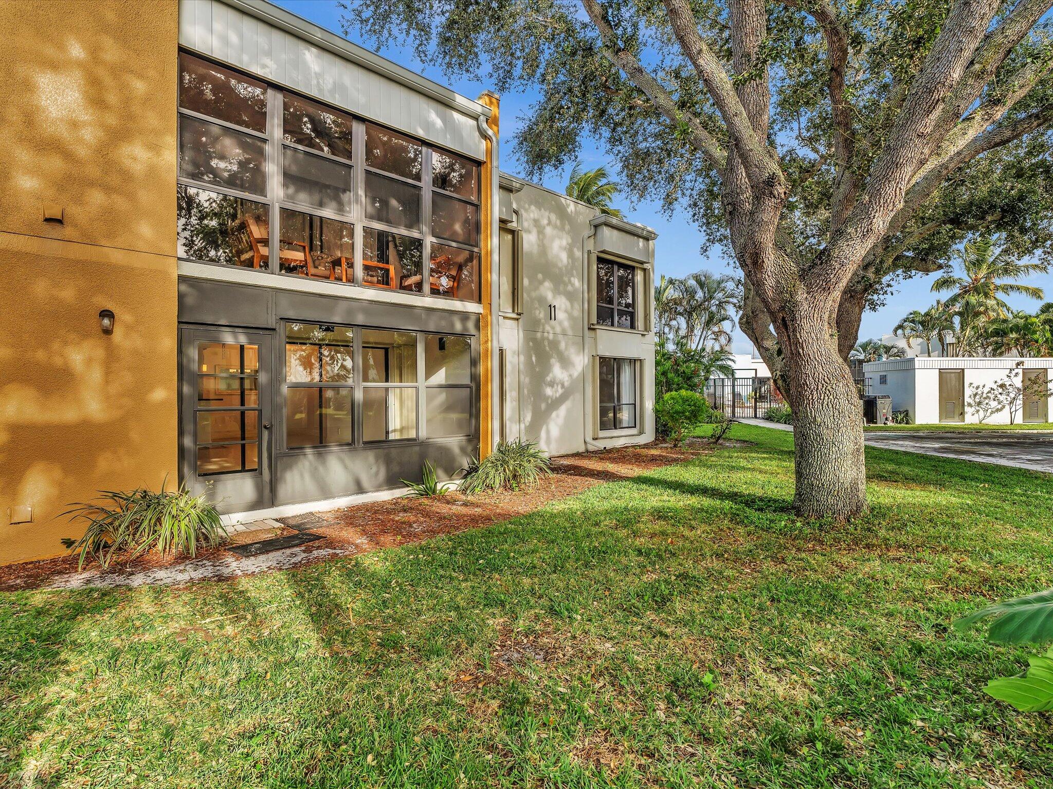524 Osprey Drive, Unit 11B Delray Beach, FL 33444 - Photo 27 of 54 a view of a house with a yard