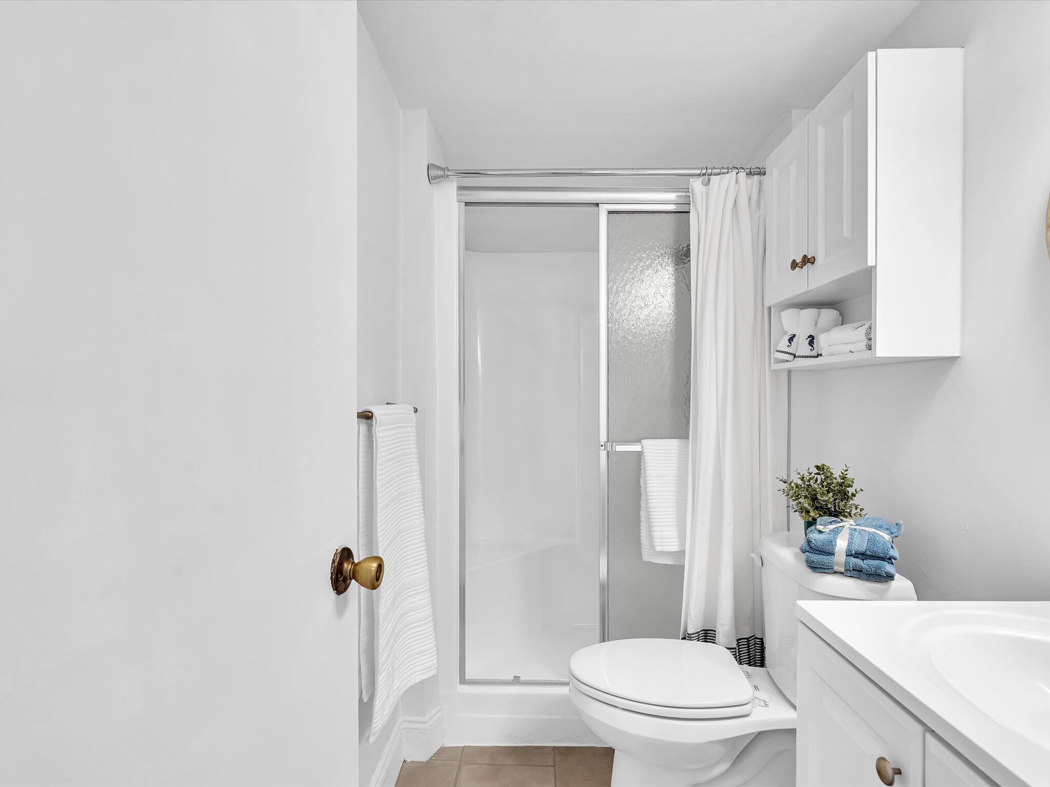 524 Osprey Drive, Unit 11B Delray Beach, FL 33444 - Photo 28 of 54 a white toilet sitting next to a bathroom sink