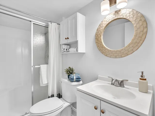 a white toilet sitting next to a bathroom sink