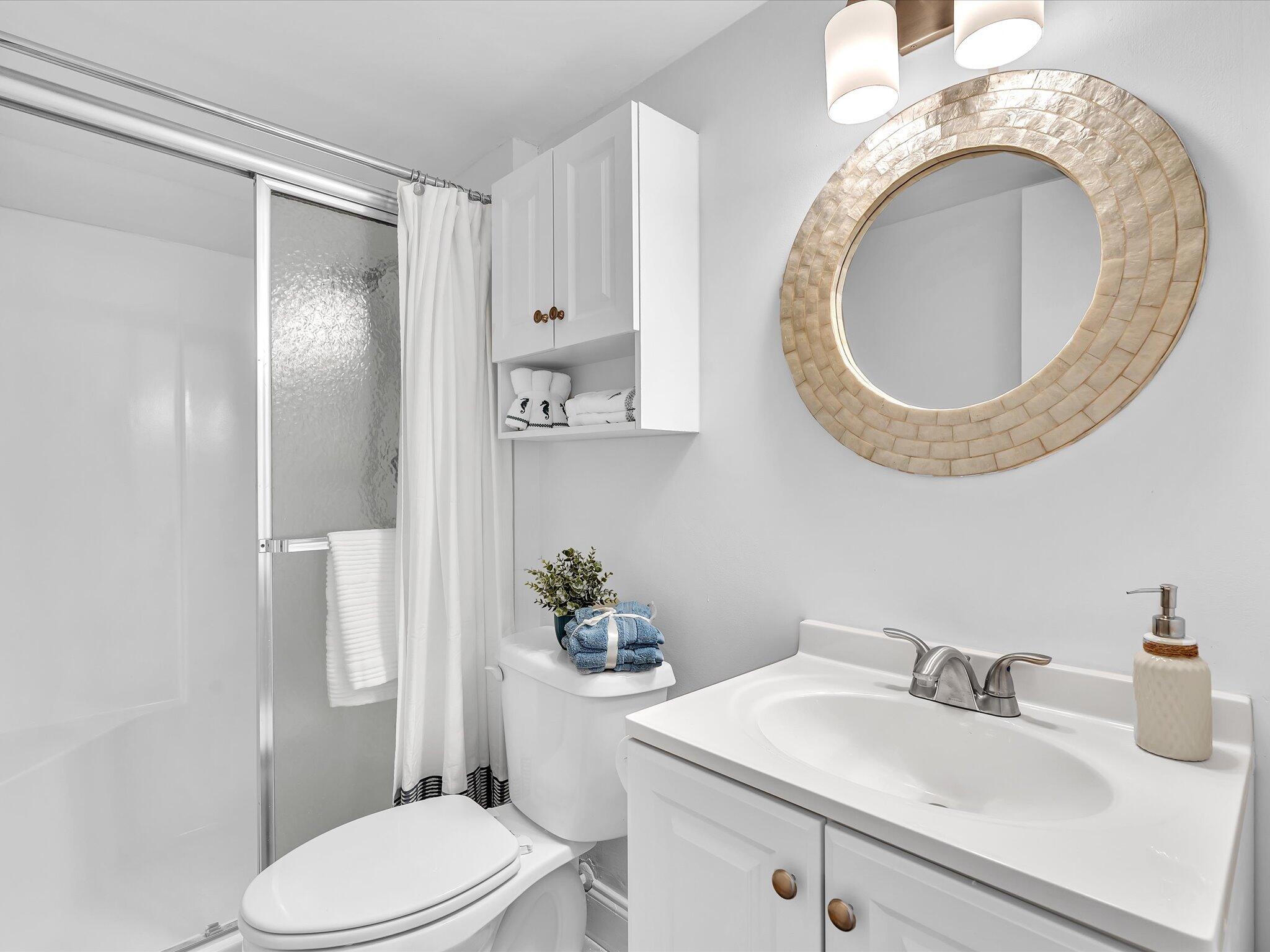 524 Osprey Drive, Unit 11B Delray Beach, FL 33444 - Photo 29 of 54 a bathroom with a sink mirror vanity and toilet
