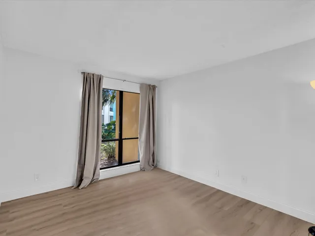 a bathroom with a sink mirror vanity and toilet