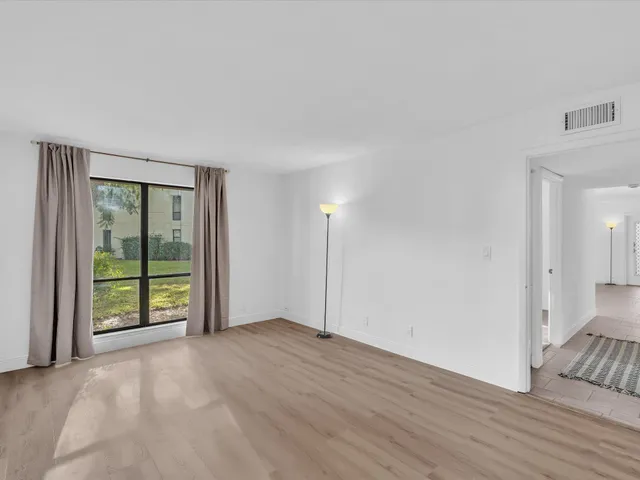 a bedroom with a bed a lamp and window