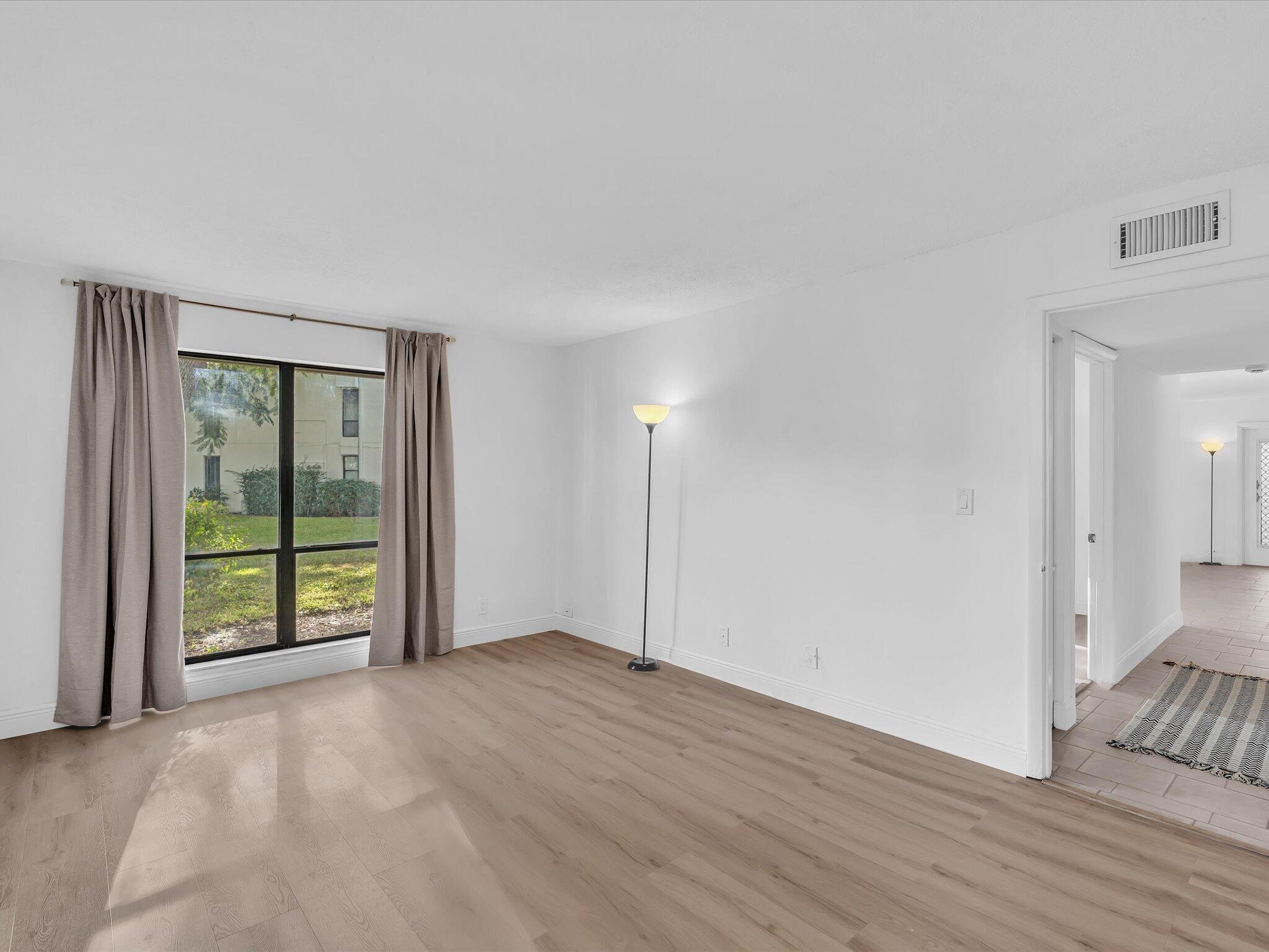 524 Osprey Drive, Unit 11B Delray Beach, FL 33444 - Photo 35 of 54 a view of an empty room with glass door