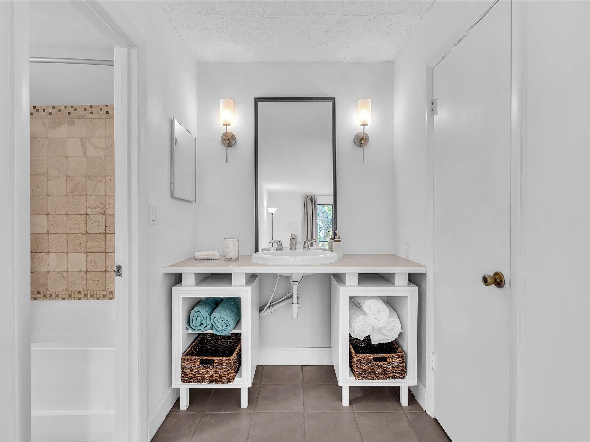 524 Osprey Drive, Unit 11B Delray Beach, FL 33444 - Photo 36 of 54 a bathroom with a sink and a mirror