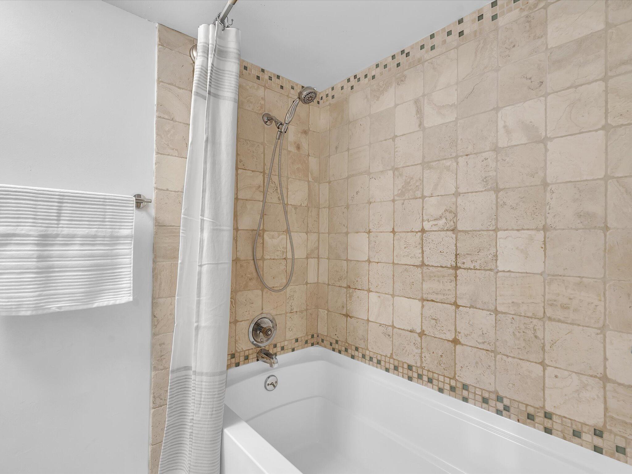 524 Osprey Drive, Unit 11B Delray Beach, FL 33444 - Photo 38 of 54 a bathroom with a bathtub and shower