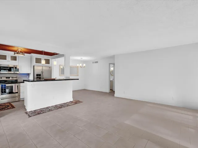 a view of kitchen and kitchen with stainless steel appliances
