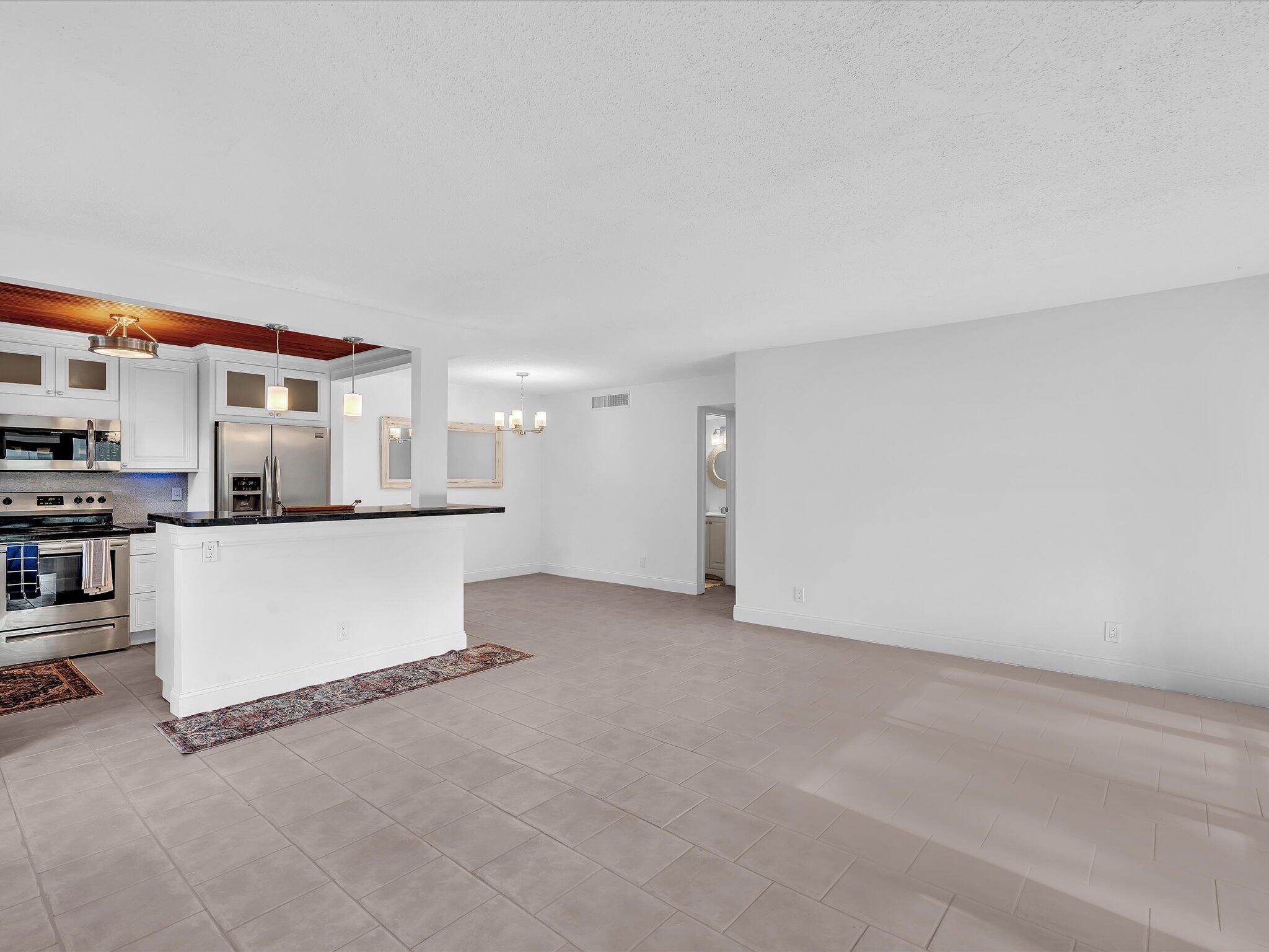 524 Osprey Drive, Unit 11B Delray Beach, FL 33444 - Photo 4 of 54 a view of kitchen and kitchen with stainless steel appliances