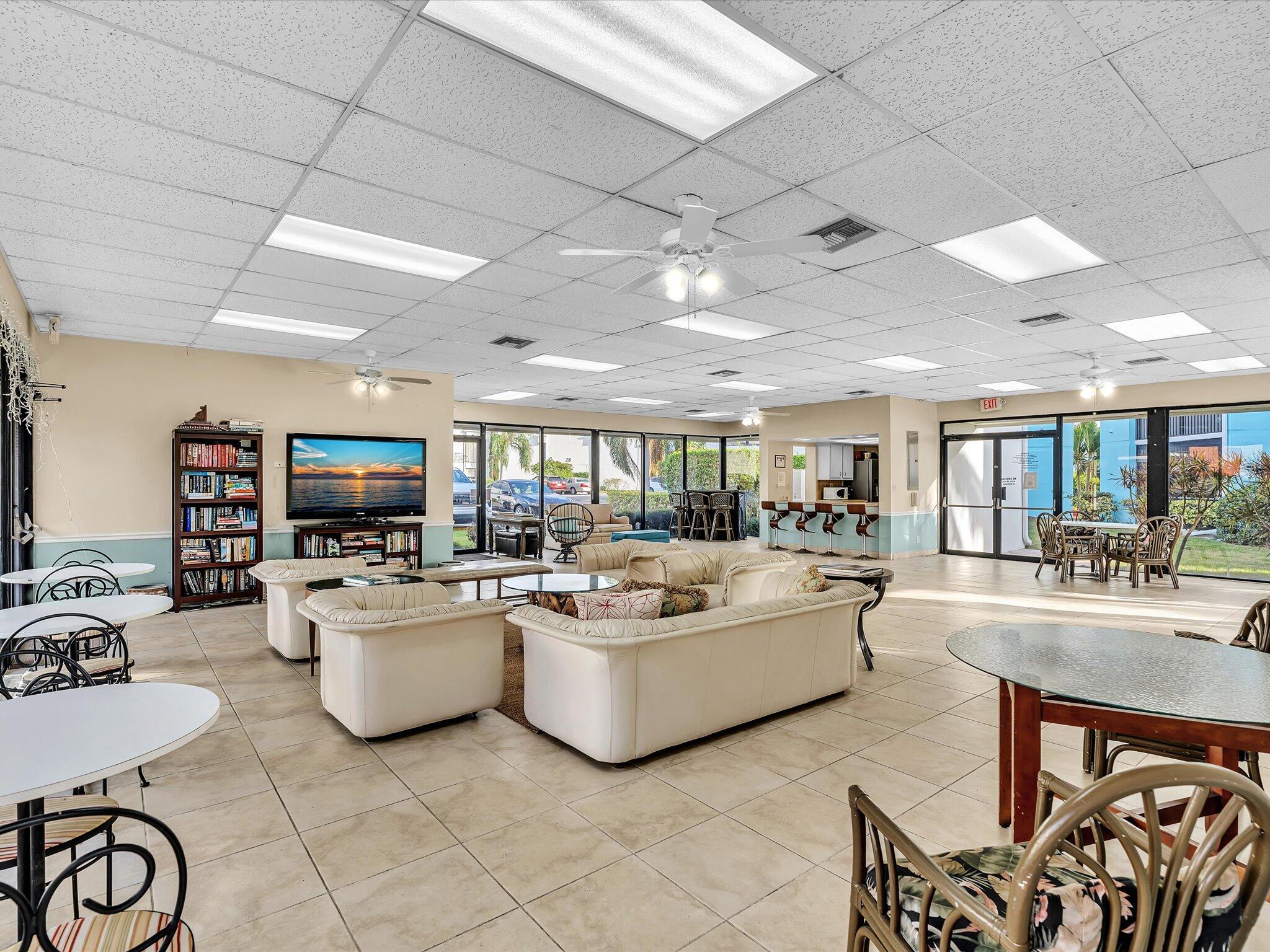 524 Osprey Drive, Unit 11B Delray Beach, FL 33444 - Photo 44 of 54 a living room with furniture and a flat screen tv