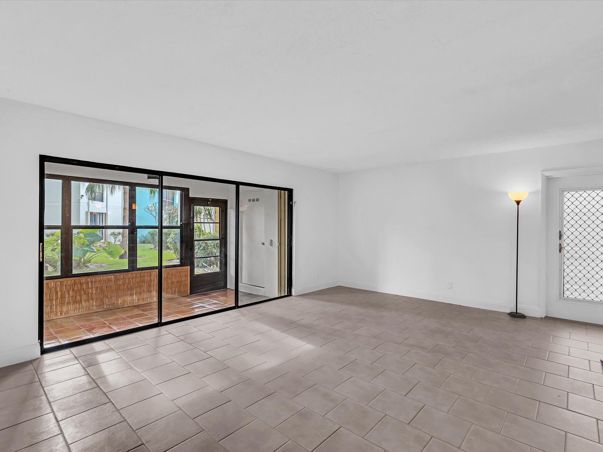 524 Osprey Drive, Unit 11B Delray Beach, FL 33444 - Photo 5 of 54 a view of an empty room with a balcony