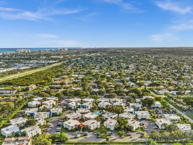 an aerial view of residential building and ocean