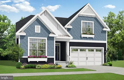 a front view of a house with a yard and potted plants