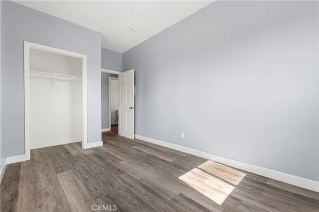 a view of an empty room and wooden floor