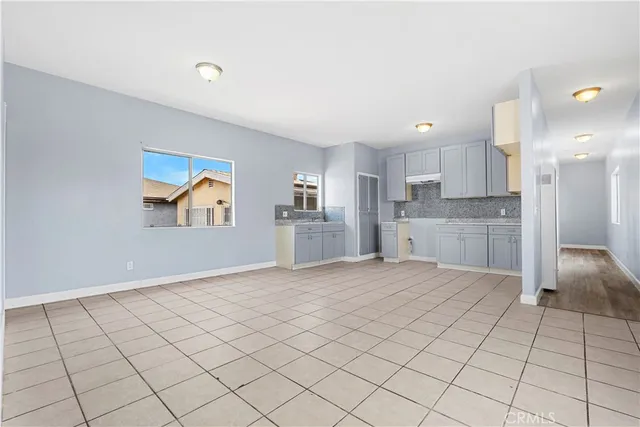 a kitchen with a stove sink and cabinets