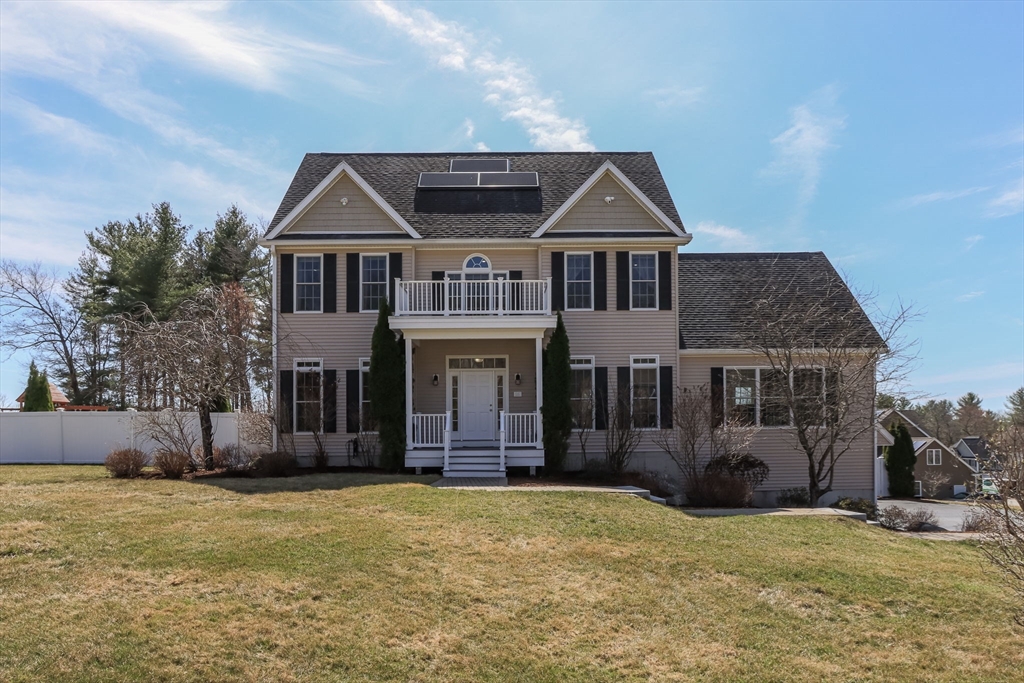 a front view of a house with a yard