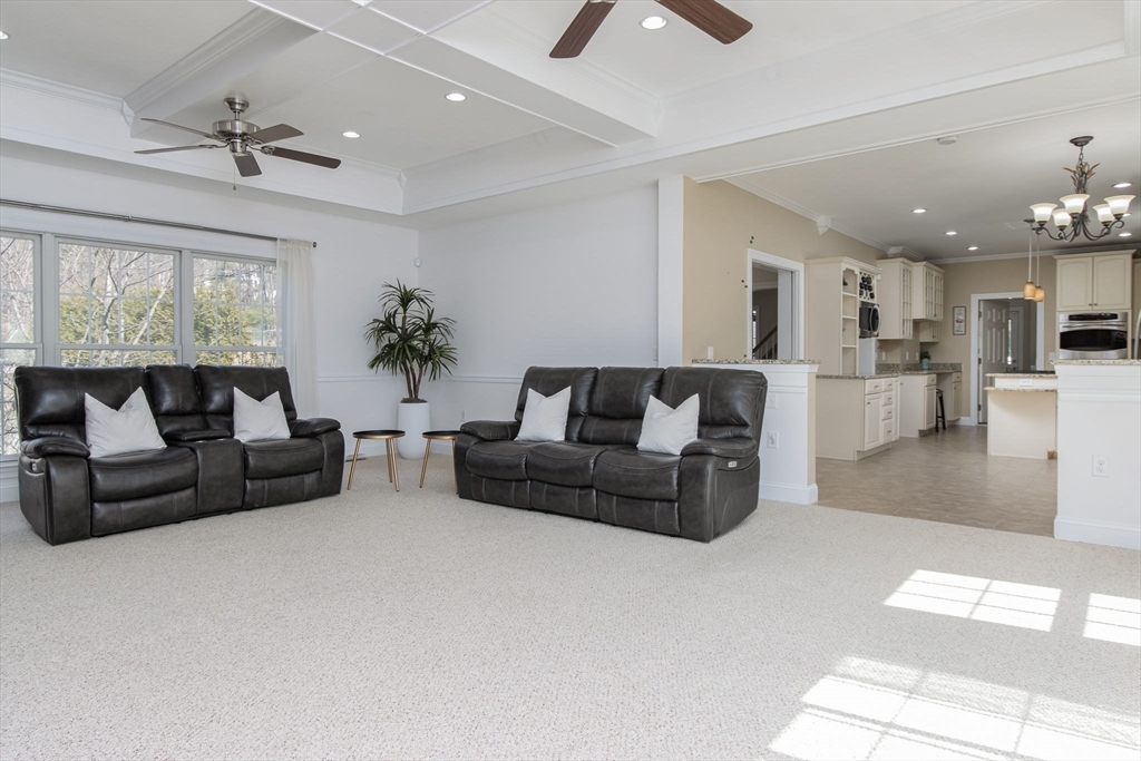 16 Mountain Laurel Road Ayer, MA 01432 - Photo 12 of 39 a living room with furniture and a chandelier