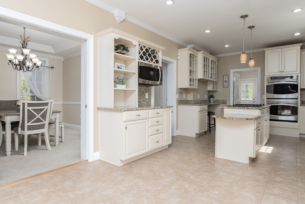 16 Mountain Laurel Road Ayer, MA 01432 - Photo 9 of 39 a kitchen with white cabinets and stainless steel appliances