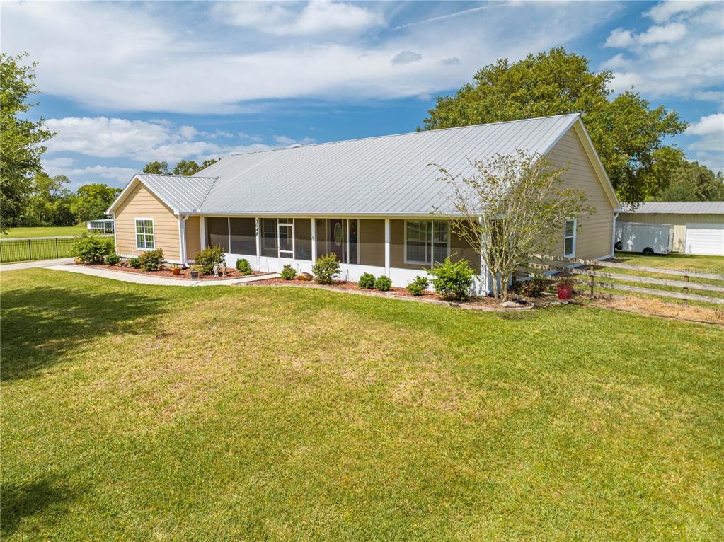 3048 Cherokee Road St. Cloud, FL 34772 - Photo 1 of 1 a front view of a house with a garden and yard