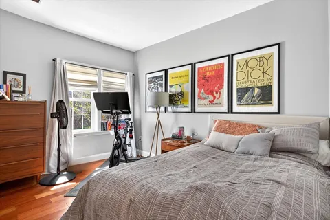 a bedroom with bed and large window
