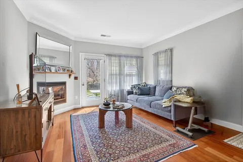 a living room with furniture rug and window