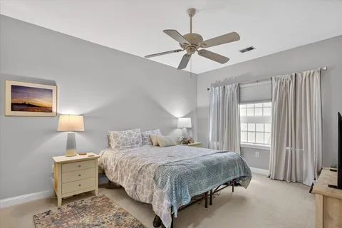 a bedroom with a bed and window