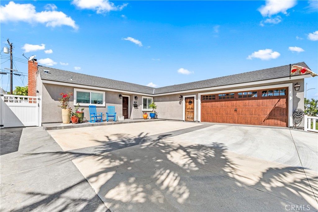 Pristine entry with four parking spaces, a 2-car garage and RV parking with hookups.