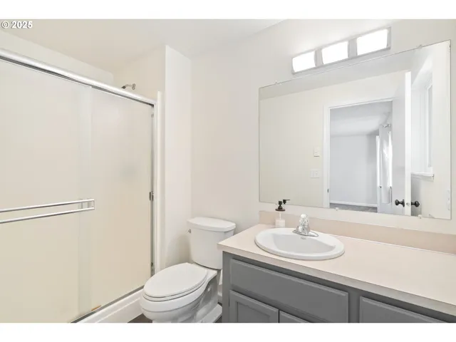 a bathroom with a sink toilet and a mirror