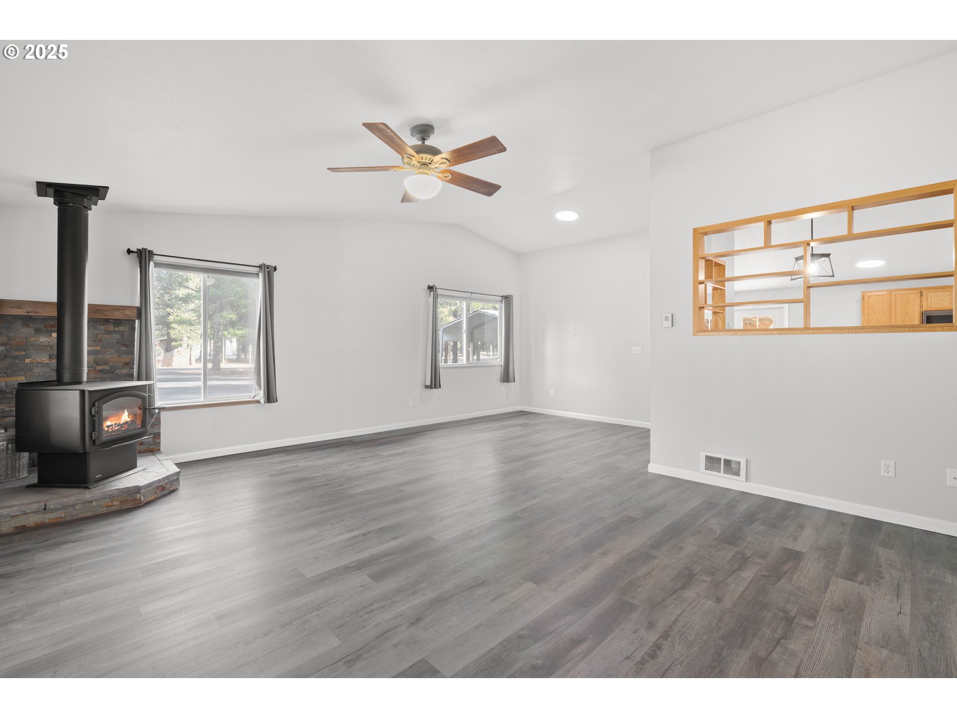 15711 Deedon Lane La Pine, OR 97739 - Photo 3 of 29 a view of an empty room with a window and wooden floor