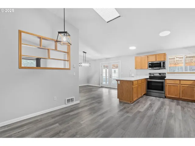 a view of kitchen with sink microwave and cabinets