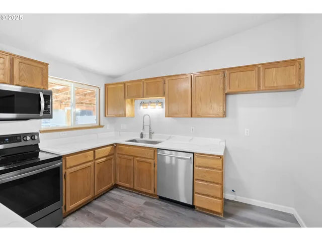 a kitchen with a sink stove and cabinets