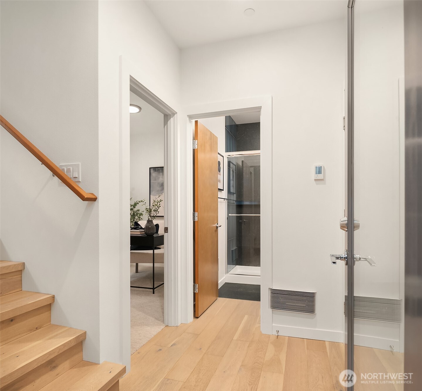 2617 3rd Avenue West Seattle, WA 98119 - Photo 3 of 30 a view of a hallway with wooden floor and living room