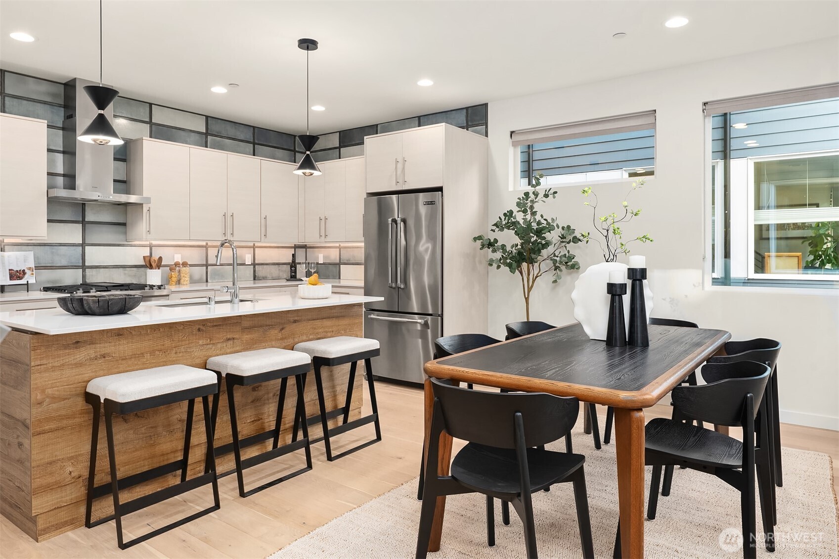 2617 3rd Avenue West Seattle, WA 98119 - Photo 6 of 30 a kitchen with a table chairs refrigerator and microwave