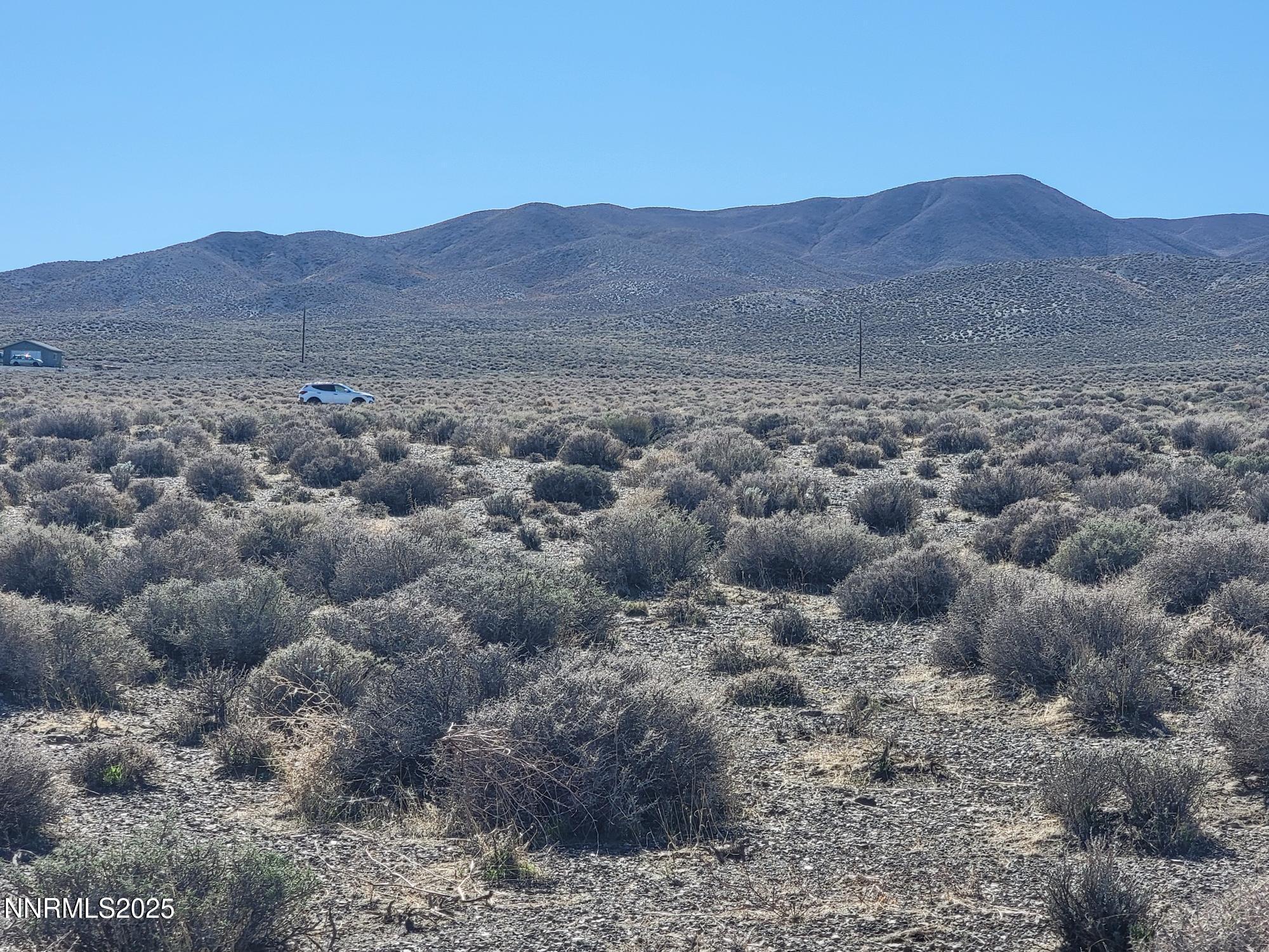 3090 Curtis Avenue Silver Springs, NV 89429 - Photo 1 of 17 a view of a house with a mountain view