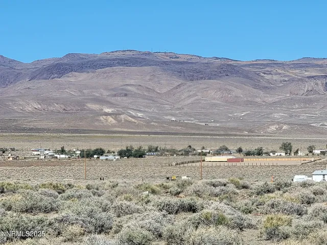 a view of a road with mountains in the background