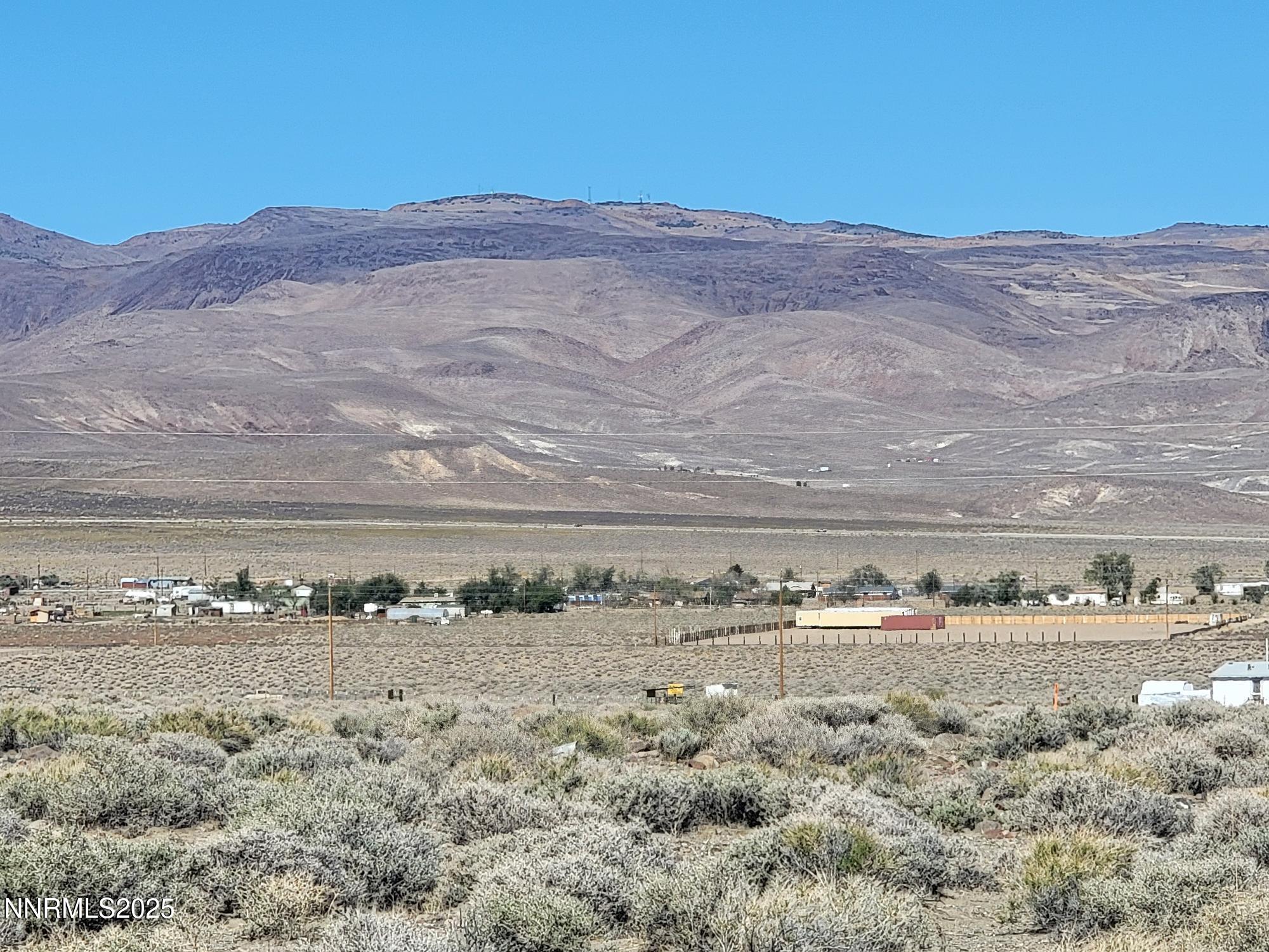 3090 Curtis Avenue Silver Springs, NV 89429 - Photo 2 of 17 a view of a road with mountains in the background