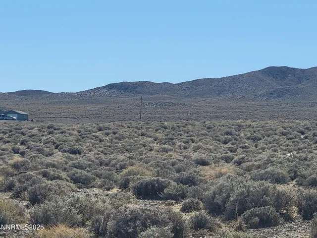 a view of a large mountain with a mountain in the background