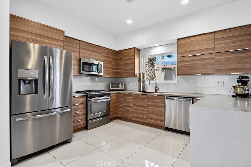9640 Hoylake Road Desert Hot Springs, CA 92240 - Photo 2 of 46 a kitchen with granite countertop stainless steel appliances and cabinets