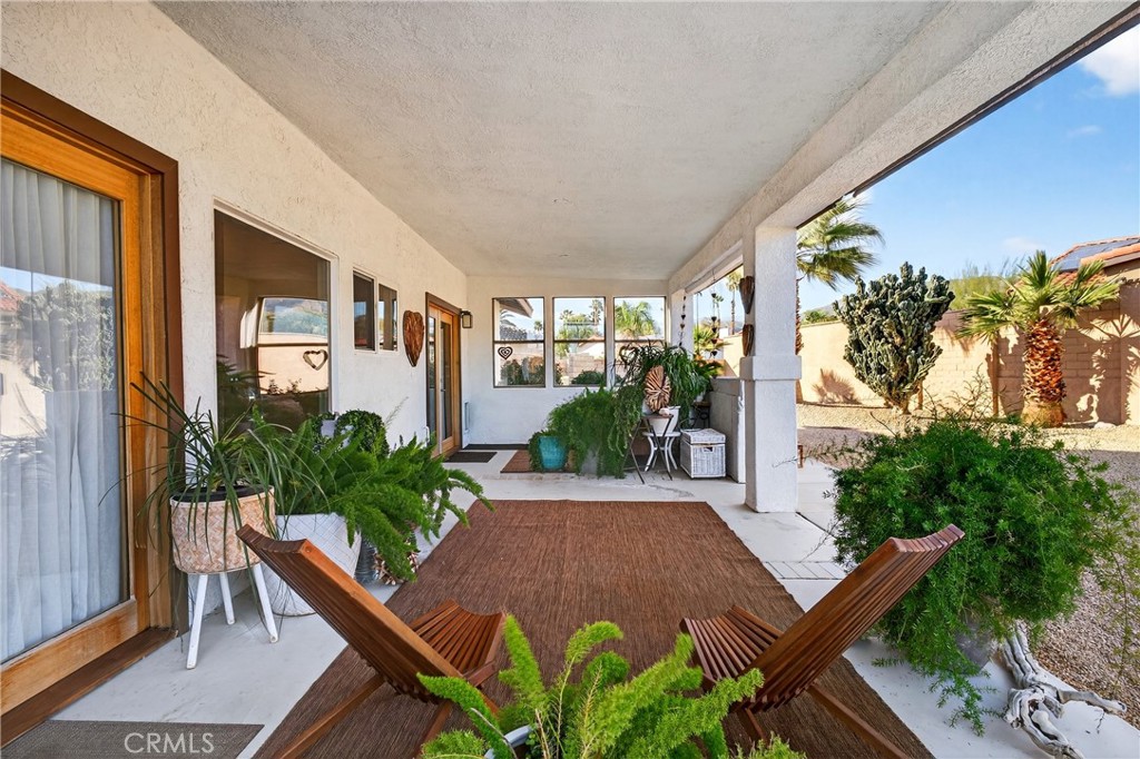9640 Hoylake Road Desert Hot Springs, CA 92240 - Photo 26 of 46 a view of an entryway with a flower garden