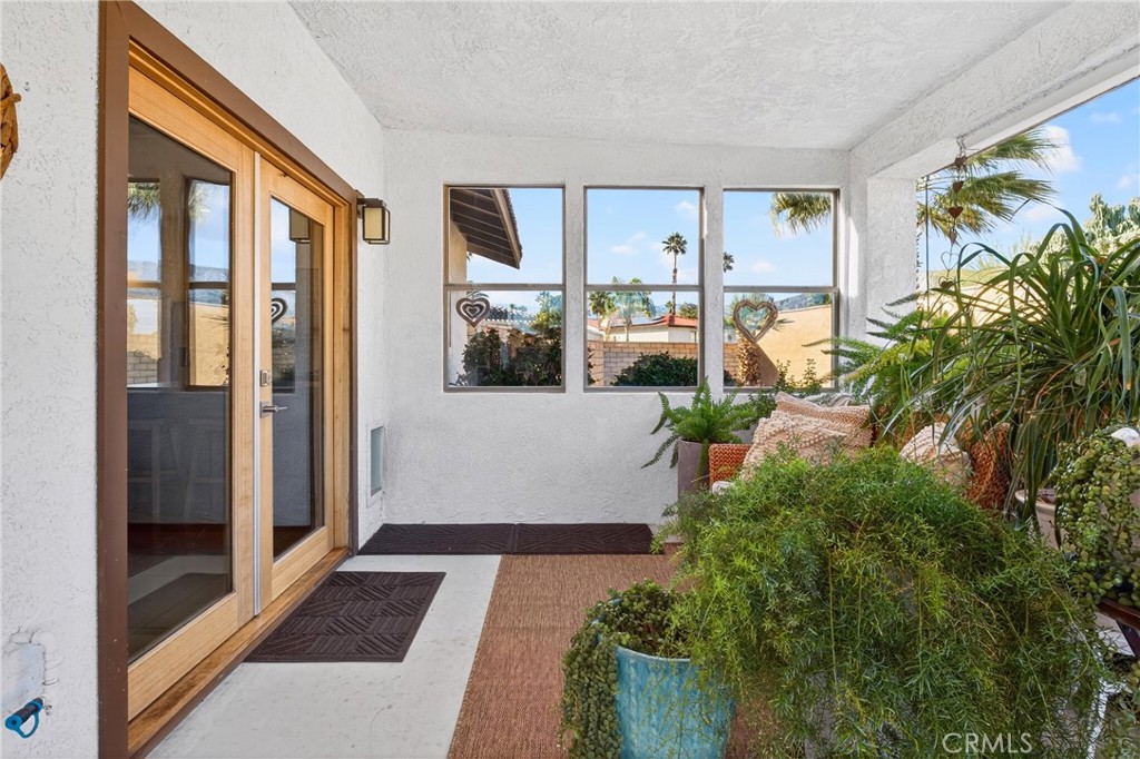 9640 Hoylake Road Desert Hot Springs, CA 92240 - Photo 27 of 46 a view of a entryway with furniture and floor to ceiling window