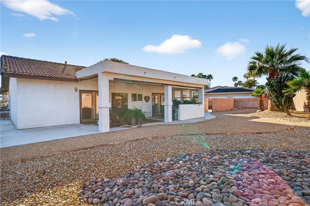 9640 Hoylake Road Desert Hot Springs, CA 92240 - Photo 30 of 46 a view of a house with a yard