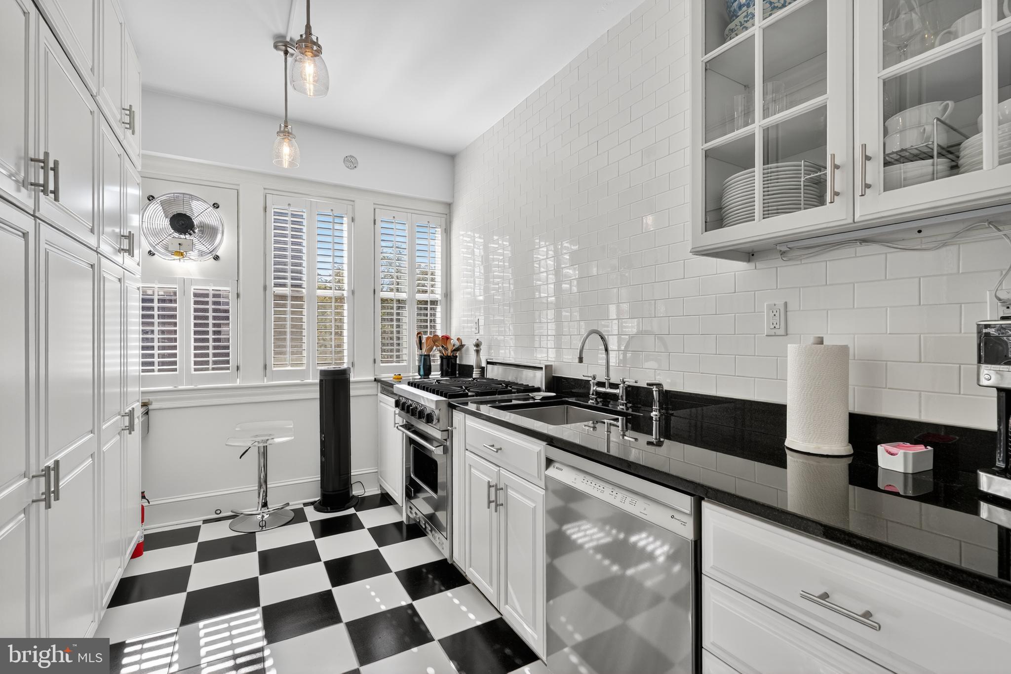 4000 Cathedral Avenue Northwest, Unit 17B Washington, DC 20016 - Photo 11 of 35 a kitchen with stainless steel appliances a sink a stove a refrigerator and cabinets