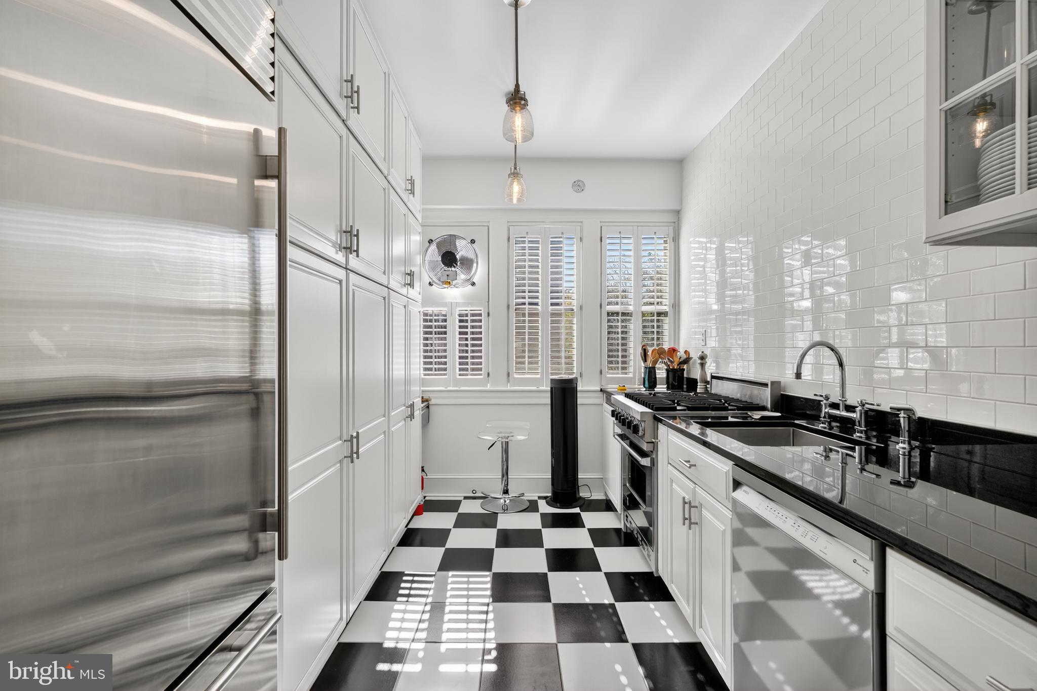 4000 Cathedral Avenue Northwest, Unit 17B Washington, DC 20016 - Photo 12 of 35 a kitchen with a sink a refrigerator and cabinets