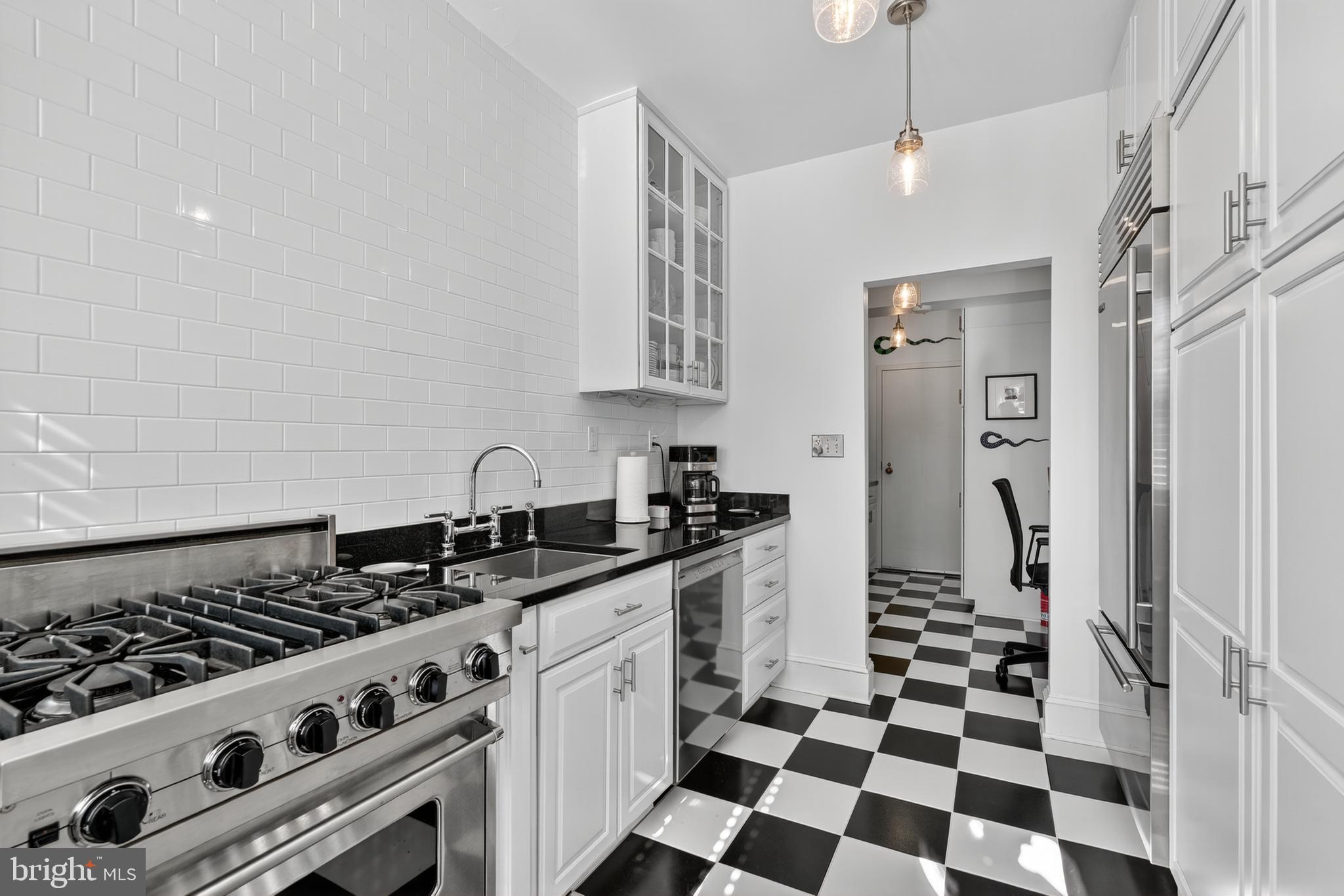 4000 Cathedral Avenue Northwest, Unit 17B Washington, DC 20016 - Photo 13 of 35 a kitchen with stainless steel appliances a stove a sink and a refrigerator
