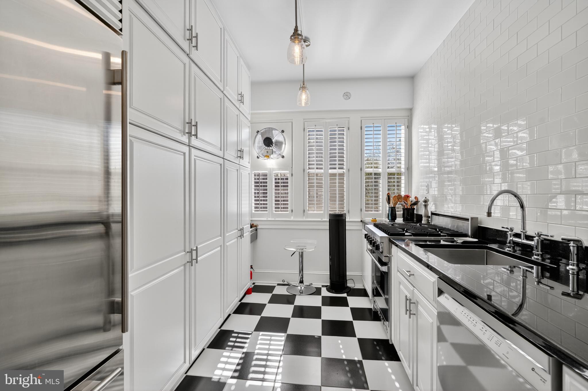 4000 Cathedral Avenue Northwest, Unit 17B Washington, DC 20016 - Photo 14 of 35 a kitchen with stainless steel appliances a sink a stove a refrigerator and cabinets